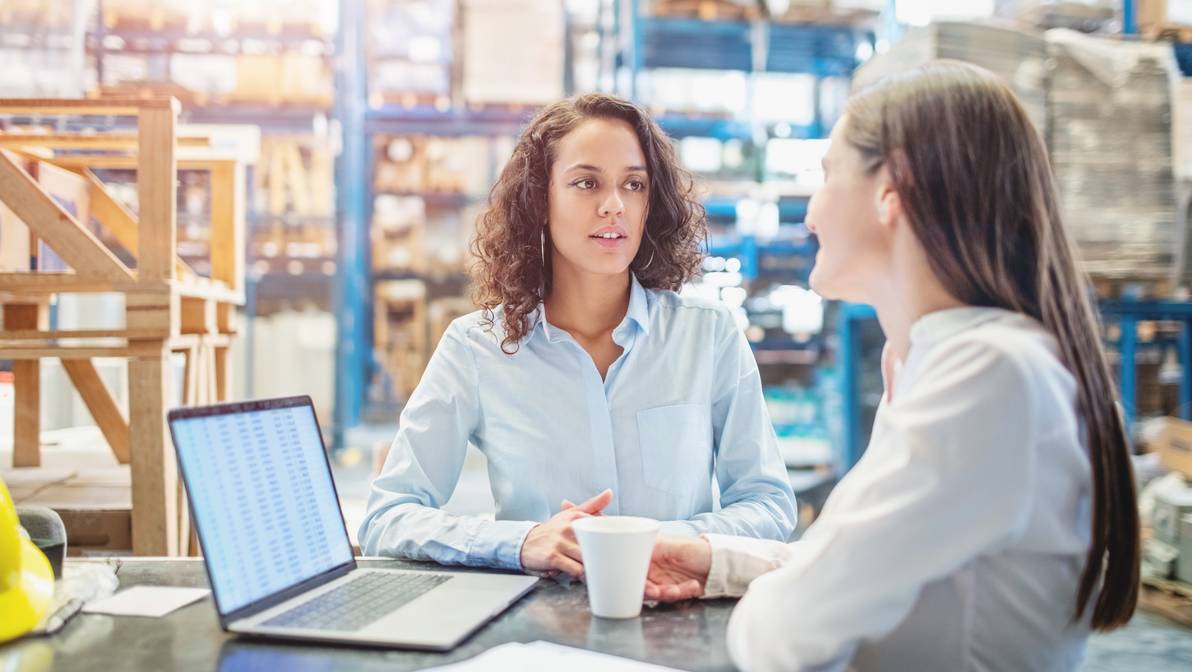 1210182368 Businesswomen discussing over available warehouse stock
