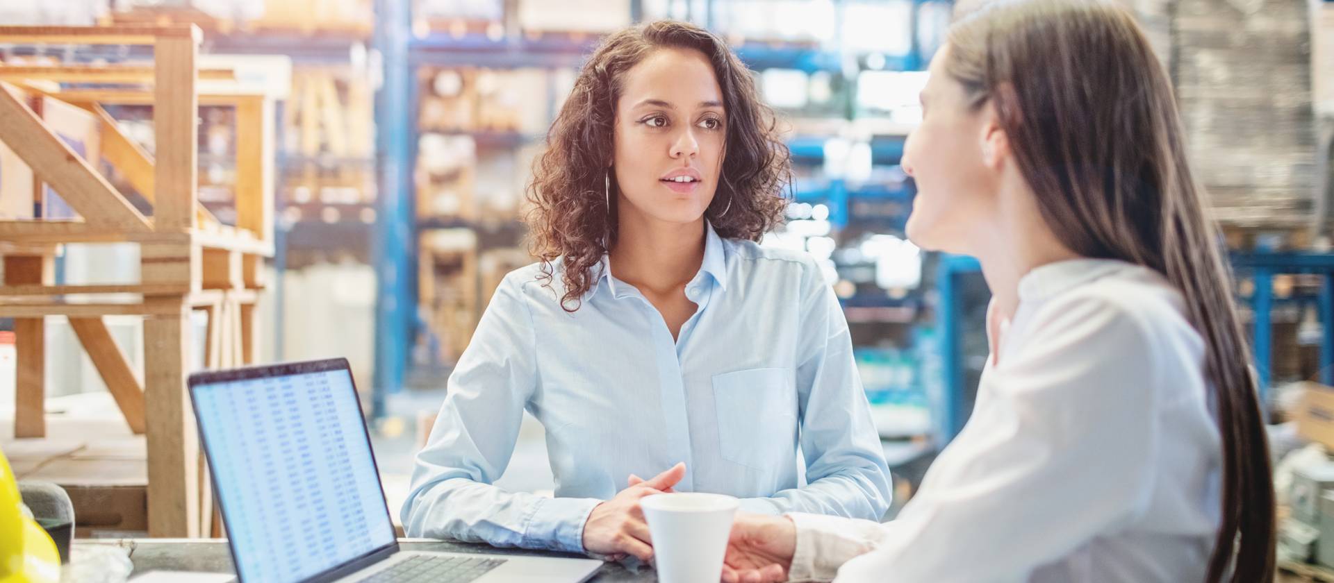 1210182368 Businesswomen discussing over available warehouse stock