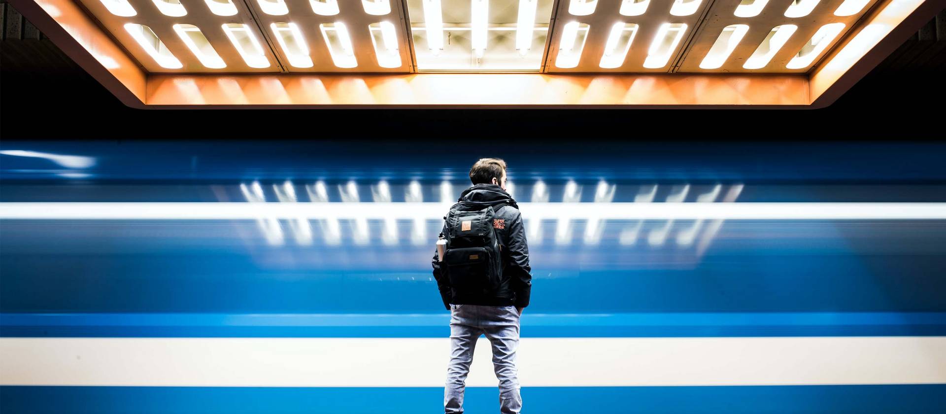 Mann von hinten warten auf die U-Bahn. Photo by William Daigneault on Unsplash
