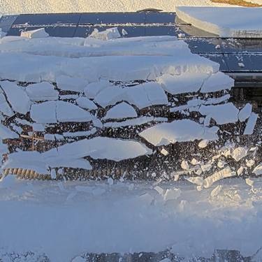 Forschende der FH Graubünden untersuchten, inwiefern es sich lohnt, Photovoltaik-Anlagen mittels Rückstrombeheizung schneefrei zu machen, um Winterstrom zu produzieren. Das Bild zeigt den Moment eines Abbruchs während einer Heiz-Phase in Davos im Winter 2024/2025.