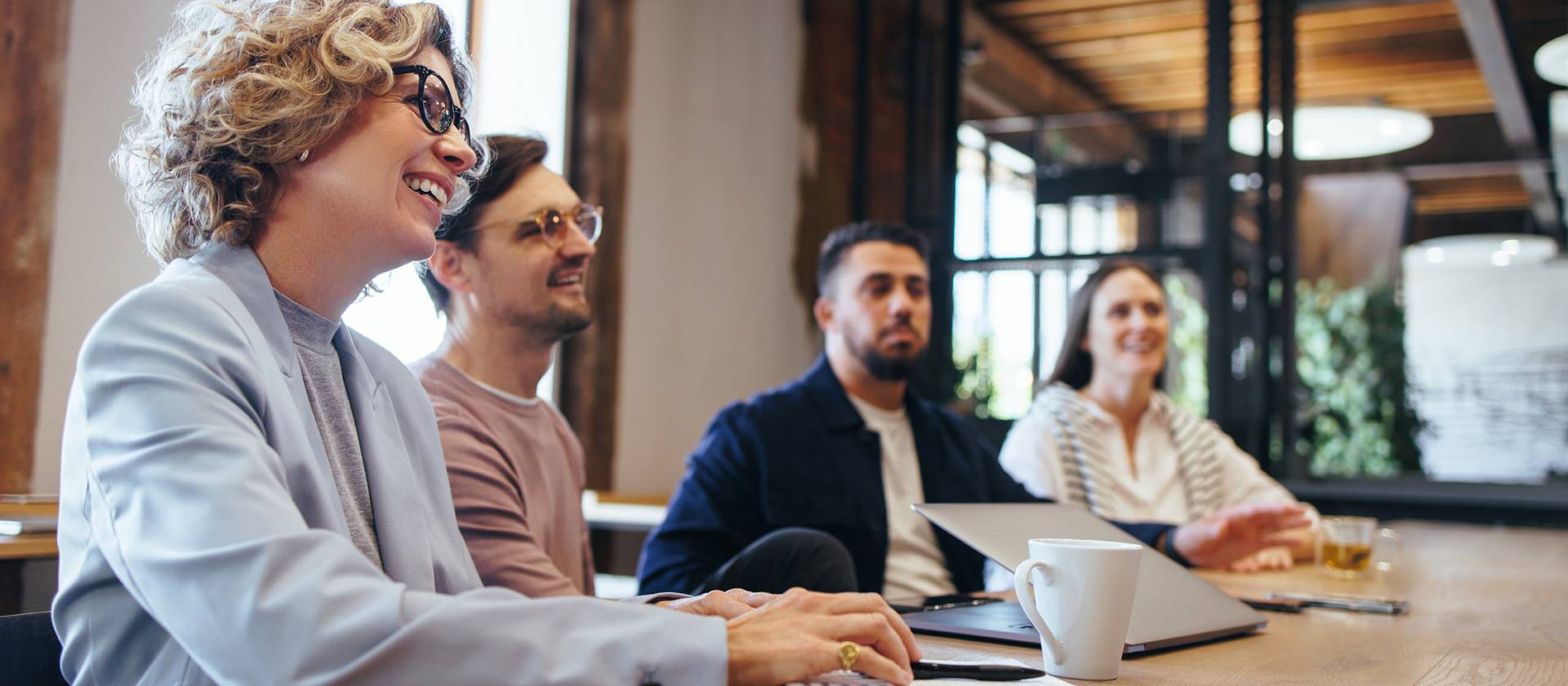 Conference meeting in an office, happy business team sits together in a boardroom