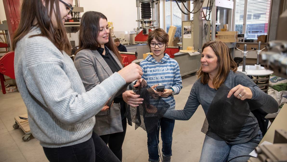 Mentorin Barbara Krummenacher erklärt den Testaufbau des Zugversuchs von Geotextilien im Baulabor der FH Graubünden.
