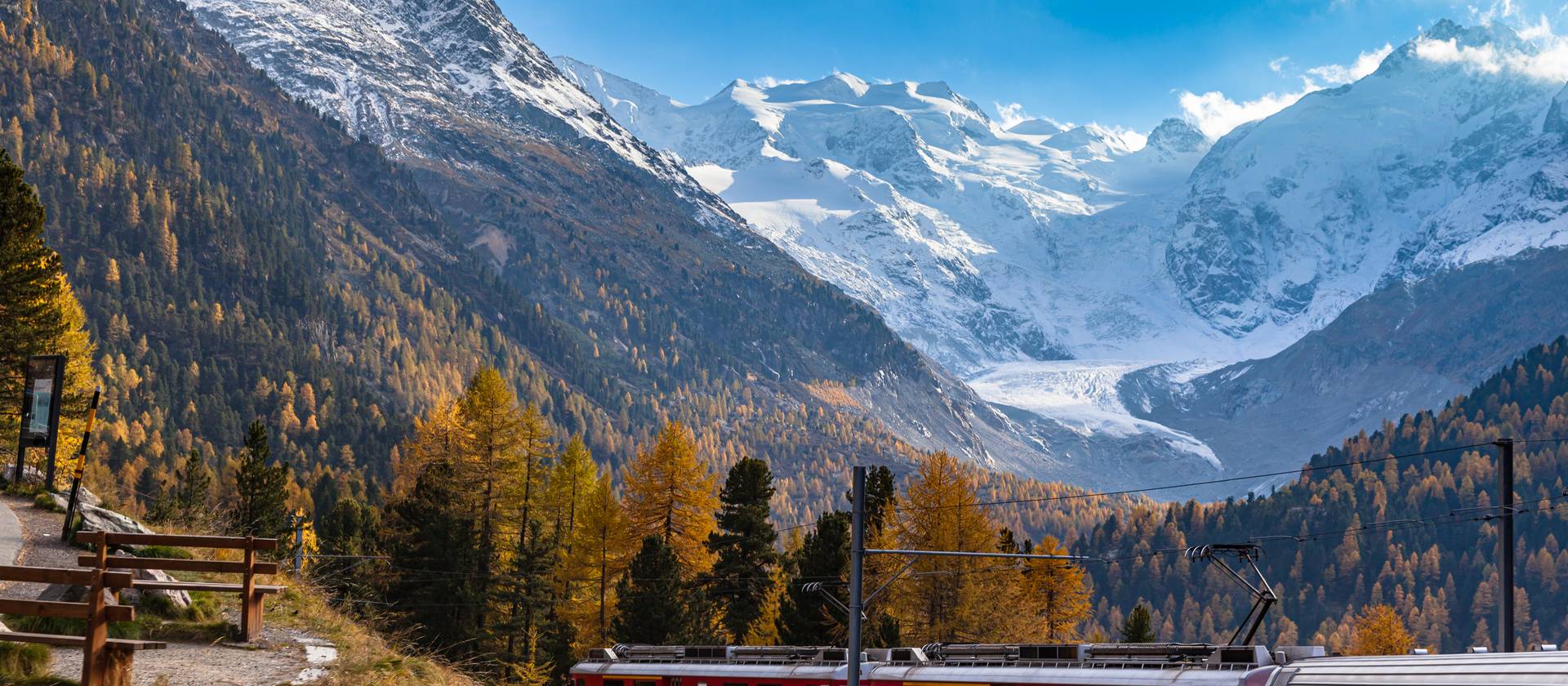 Stunning view of red Rhaetian train running under the Morteratsch Glacier, Grisons, Switzerland Stunning view of red Rhaetian train running under the Morteratsch Glacier, Grisons, Switzerland
