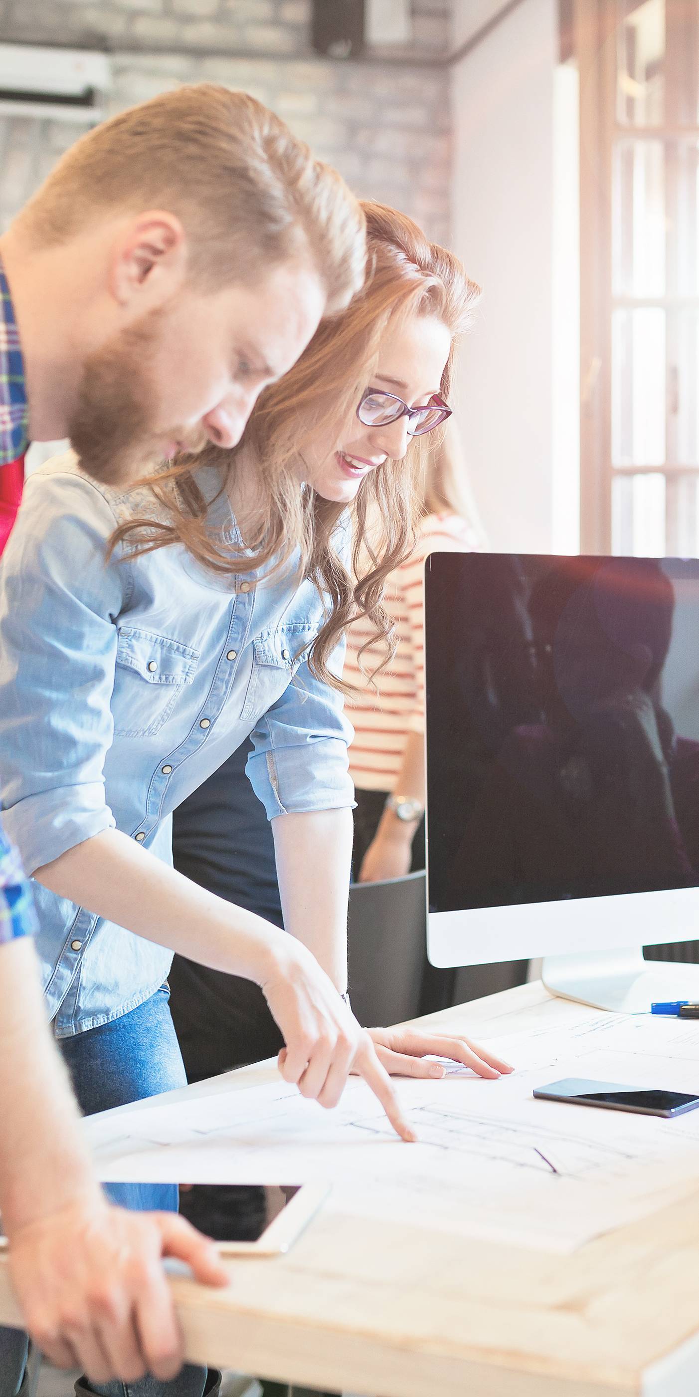 Coworkers working on project together in office