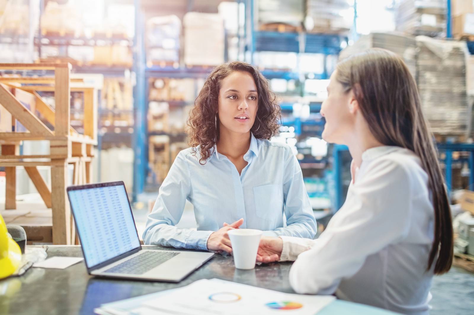 Businesswomen discussing over available warehouse stock