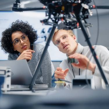 Zwei Studierende experimentieren in einem Labor.
