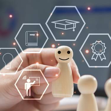 Employee training and professional development concept with wooden figures, digital learning icons and laptop. Workforce education, skill improvement, leadership training and talent management.