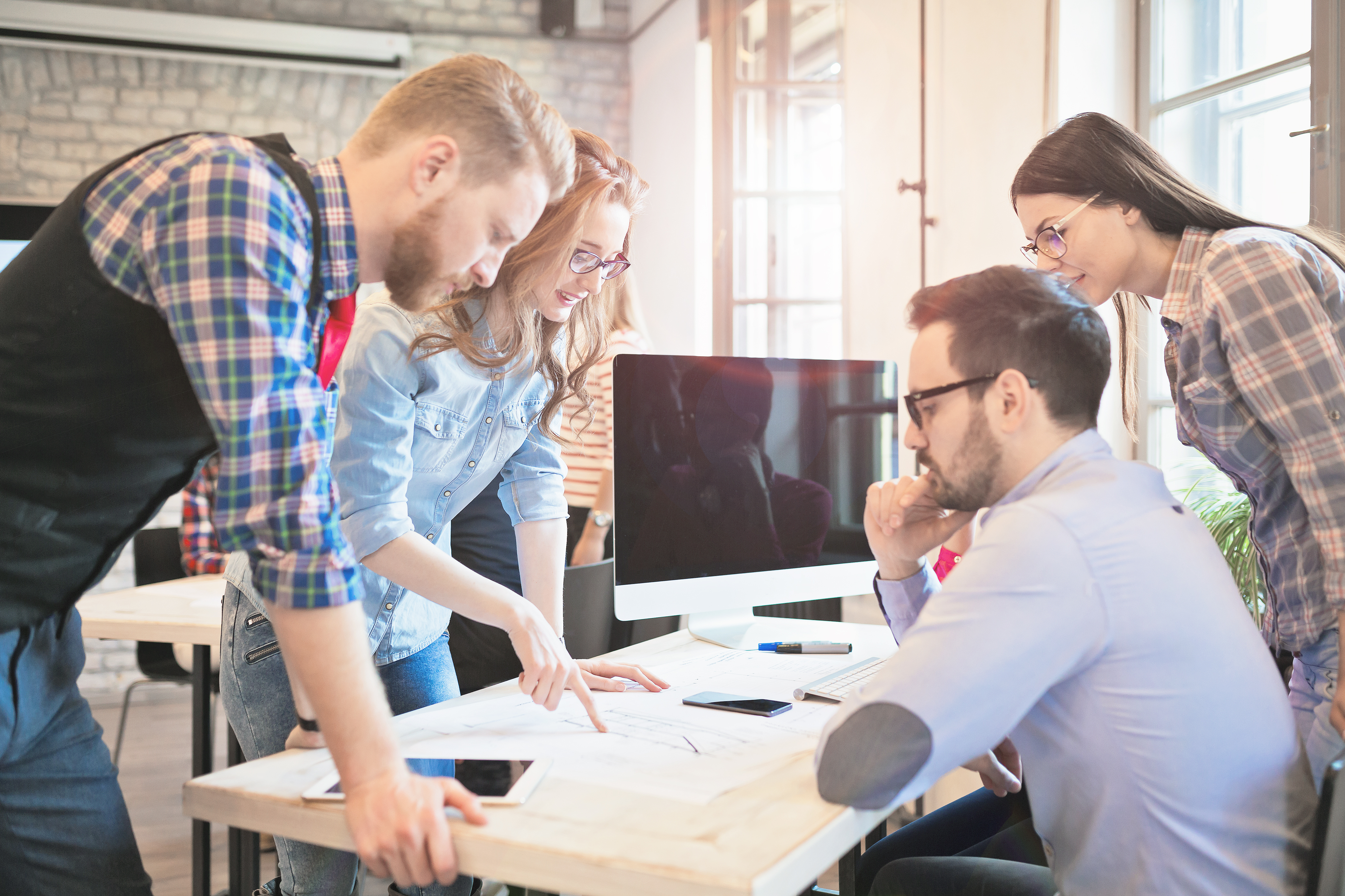 Coworkers working on project together in office
